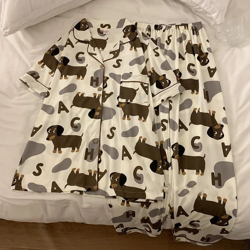 A set of dachshund-themed pajamas laid out on a surface, featuring a shirt with dachshund prints and pants.