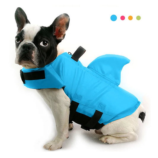 A dog wearing a blue shark-shaped life jacket.