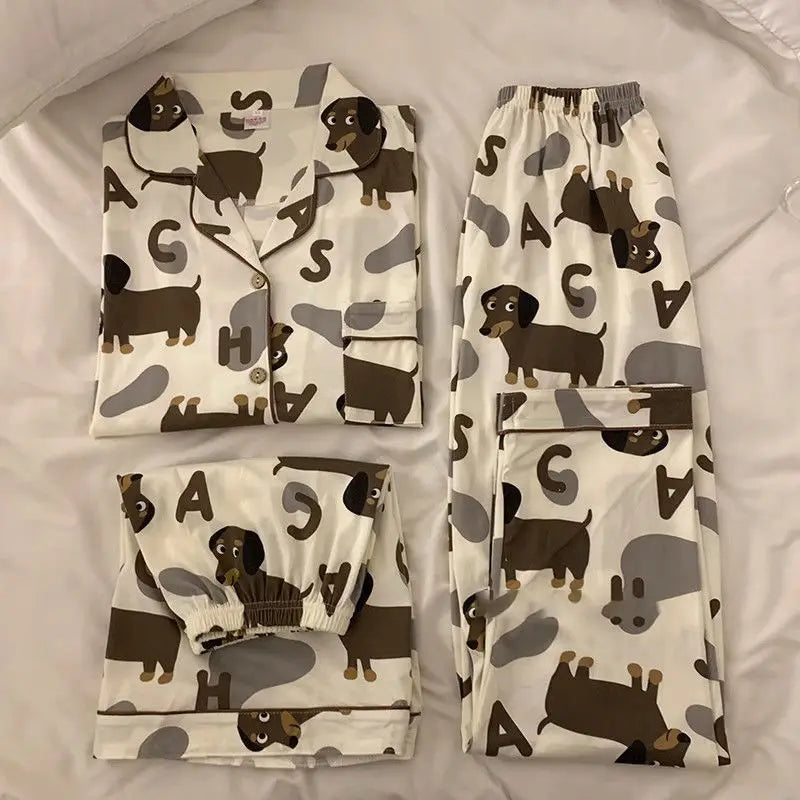 A set of dachshund-themed pajamas laid out on a surface, featuring a shirt with dachshund prints and pants.