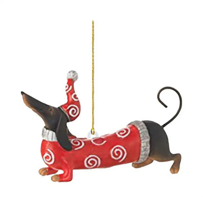 Decorative dachshund ornament wearing a red sweater with white patterns and a Santa hat on a white background.
