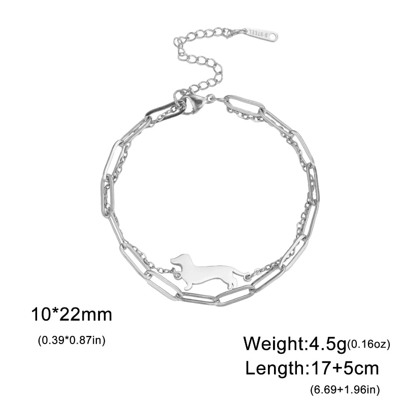 Silver bracelet with a small dog cutout on a white background