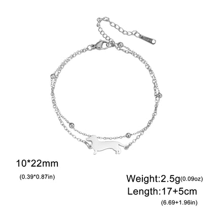Silver bracelet with a dog design on a white background