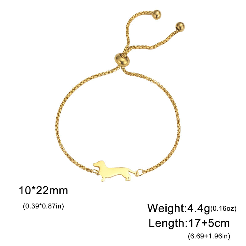 Gold bracelet with a dog design on a white background