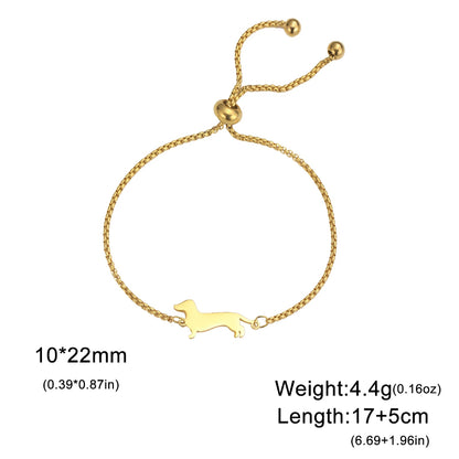 Gold bracelet with a dog design on a white background