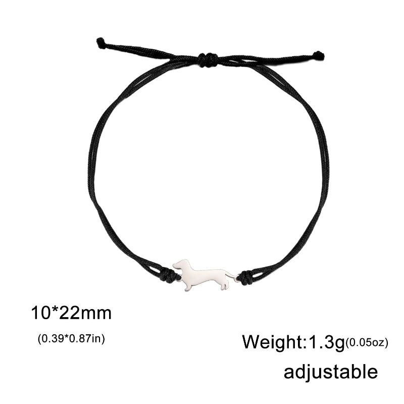 Black adjustable bracelet with a small white dog charm on a white background