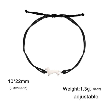 Black adjustable bracelet with a small white dog charm on a white background