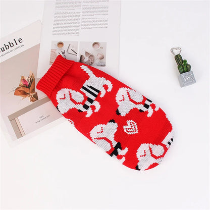 Red knitted dog sweater with white and black patterns on a magazine background