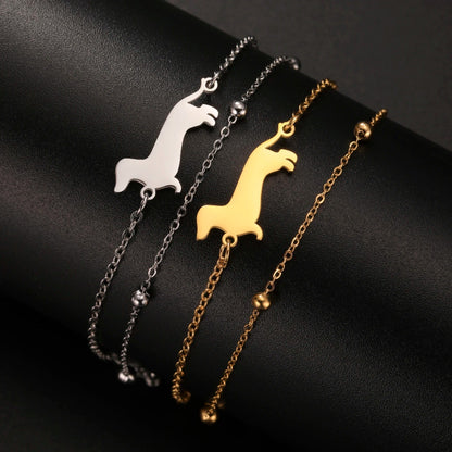 Three necklaces with llama-shaped pendants on a black background