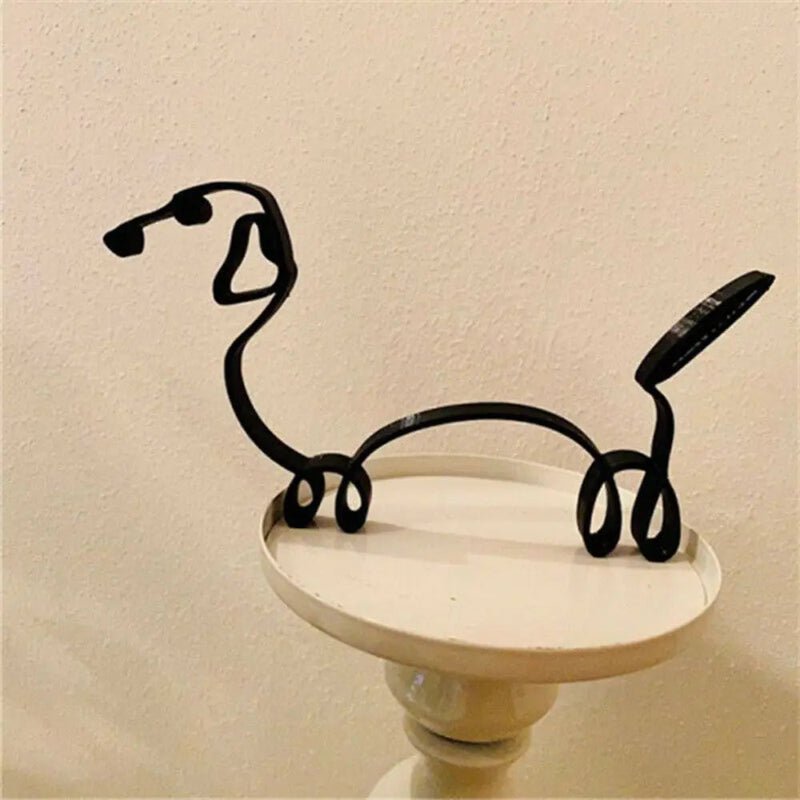 Decorative wall art with a black wire dog sculpture on a beige background