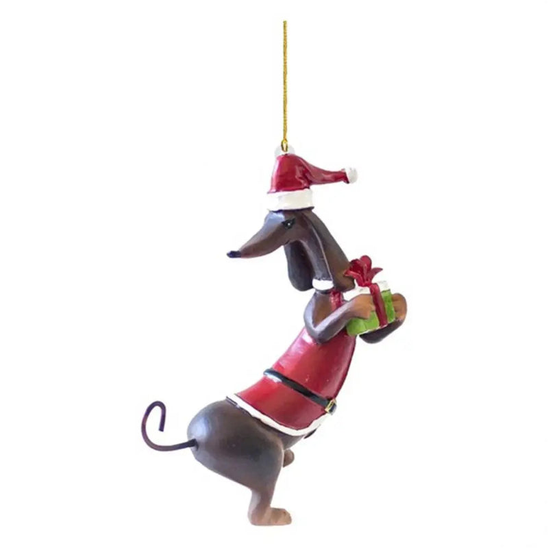 Dog Christmas ornament wearing a Santa hat and holding a gift on a white background