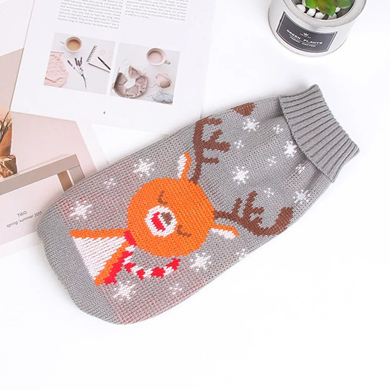 Gray dog sweater with reindeer design on a white surface
