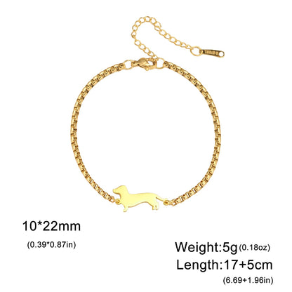 Gold bracelet with a dog-shaped charm on a white background