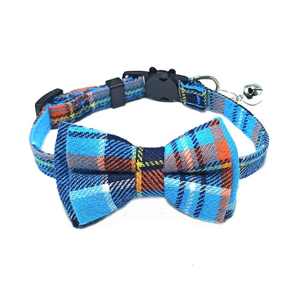 Blue plaid dog collar with bow tie and bell on a white background