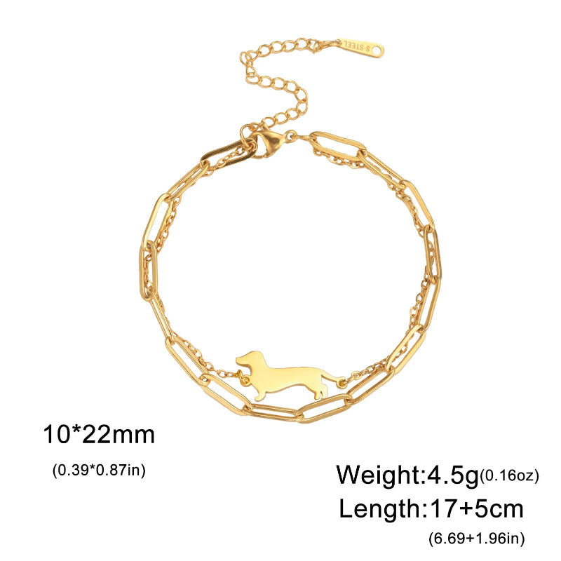 Gold bracelet with a dog-shaped pendant on a white background