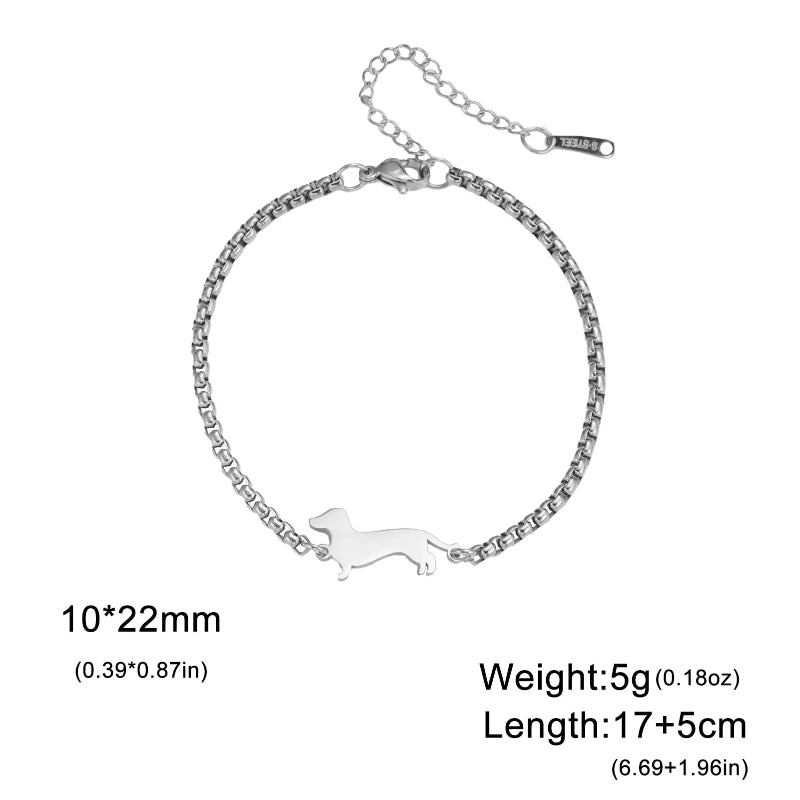 Silver bracelet with a small dog-shaped pendant on a white background