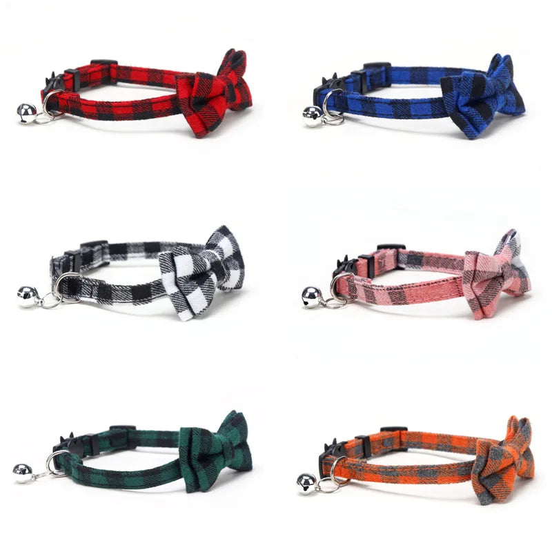 Set of plaid cat collars with bow ties and bells on a white background