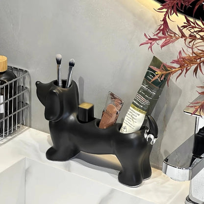 Black dog-shaped makeup brush holder on a bathroom counter with brushes and products.