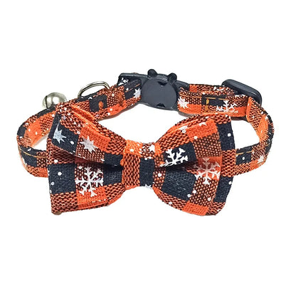 Dog collar with a bow tie featuring orange, black, and white pattern on a white background